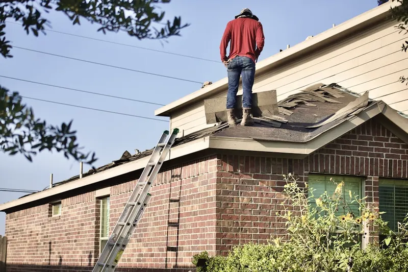 Professional roofer working on a residential roof in Delair